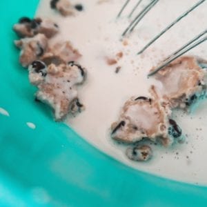 adding cookie dough bites to ice cream mixture