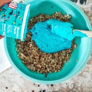 adding frosting to crumbled cake
