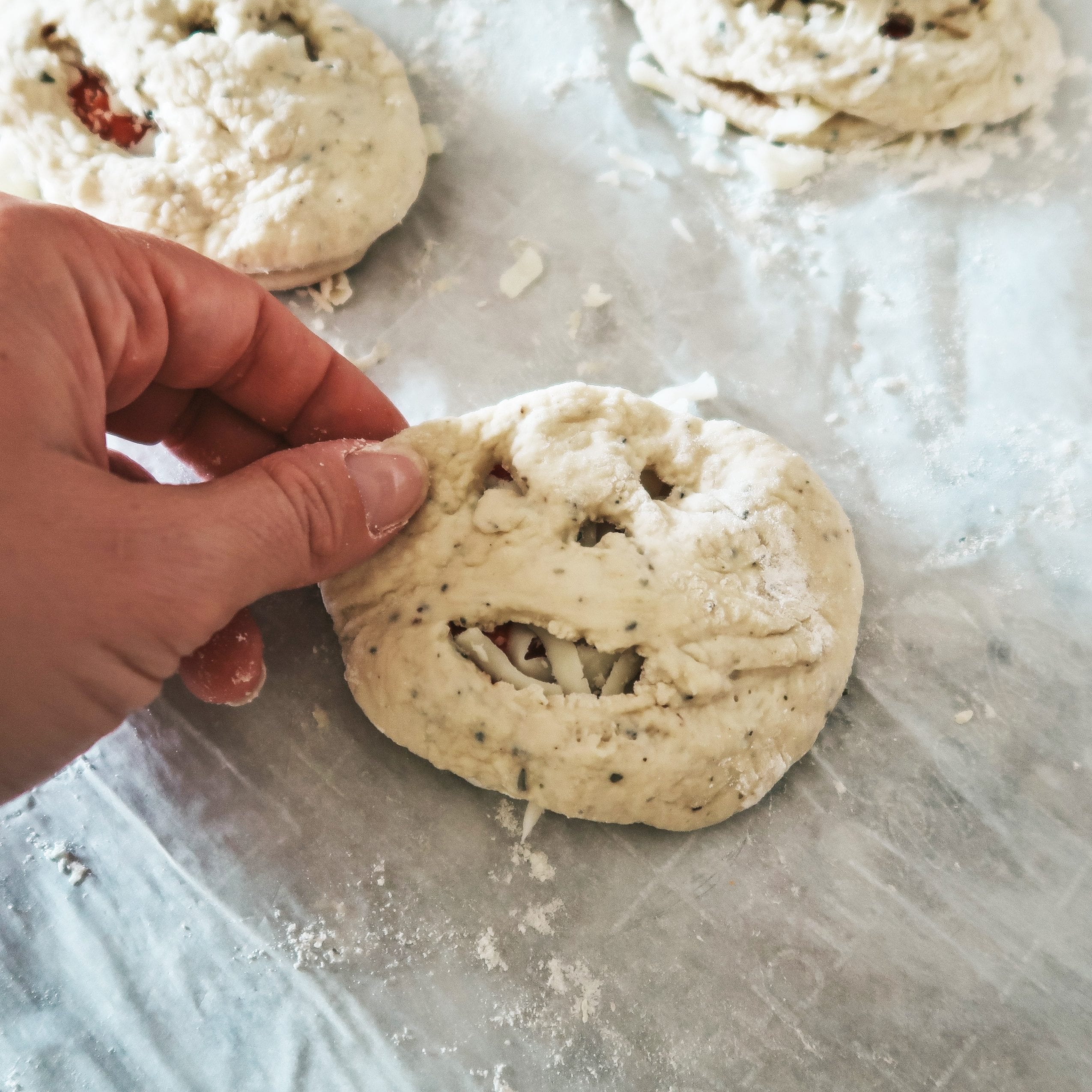adding the top dough disk to the calzone