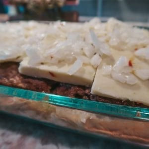 assembling hamburger sliders, adding chopped onions