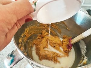 adding milk to bowl