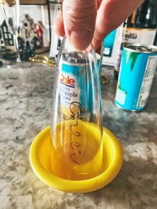 adding the pineapple juice on the rim of the glass