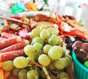 Fruits and meats on charcuterie board
