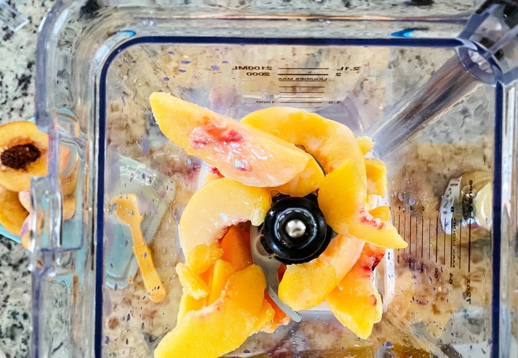 adding frozen peaches to blender