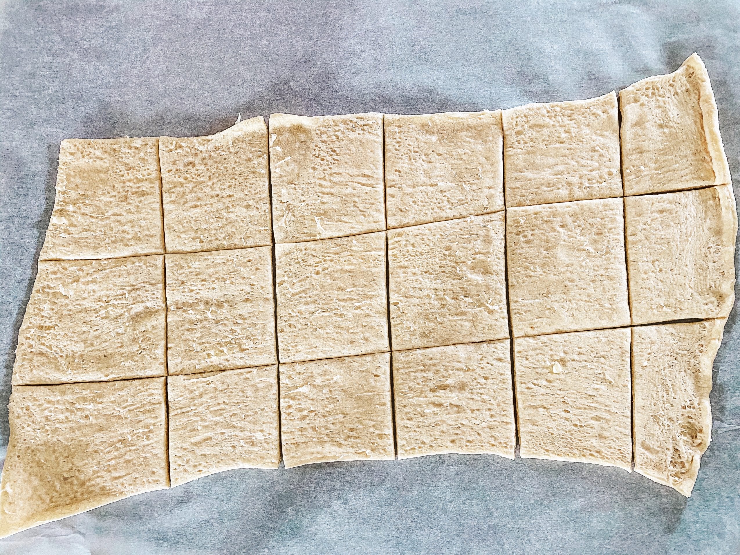 Cutting the Pillsbury Crescent Dough Sheet for Cream Cheese and Sausage Pastries