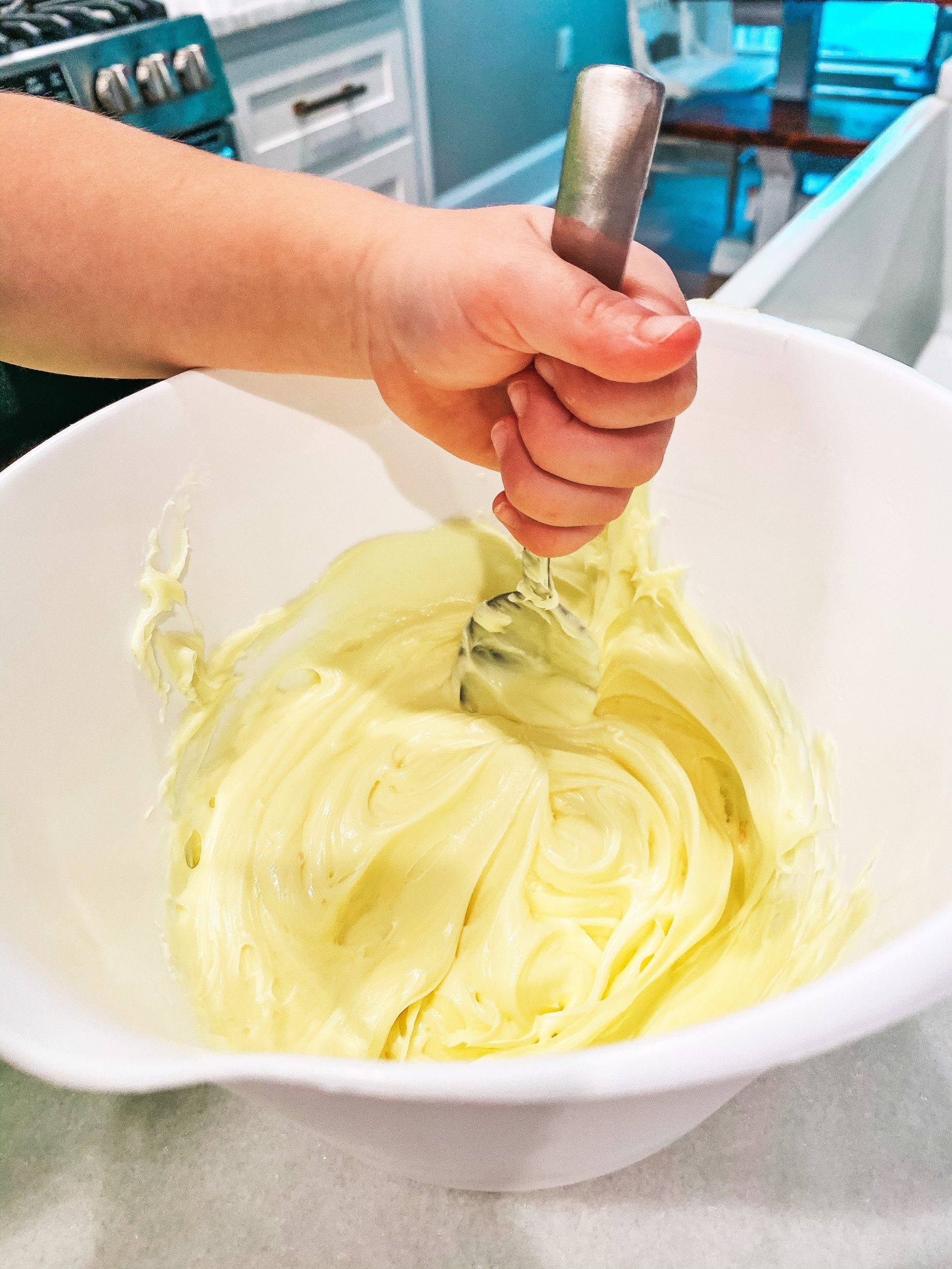 Mixing the lemon frosting with lemon extract