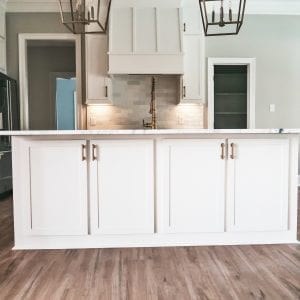 kitchen with white cabinets and marble countertops