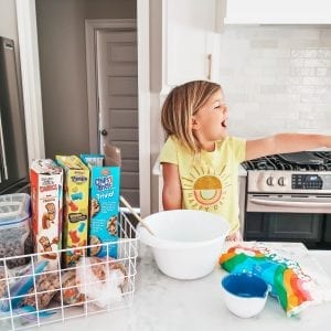 toddler in the kitchen making cereal bars