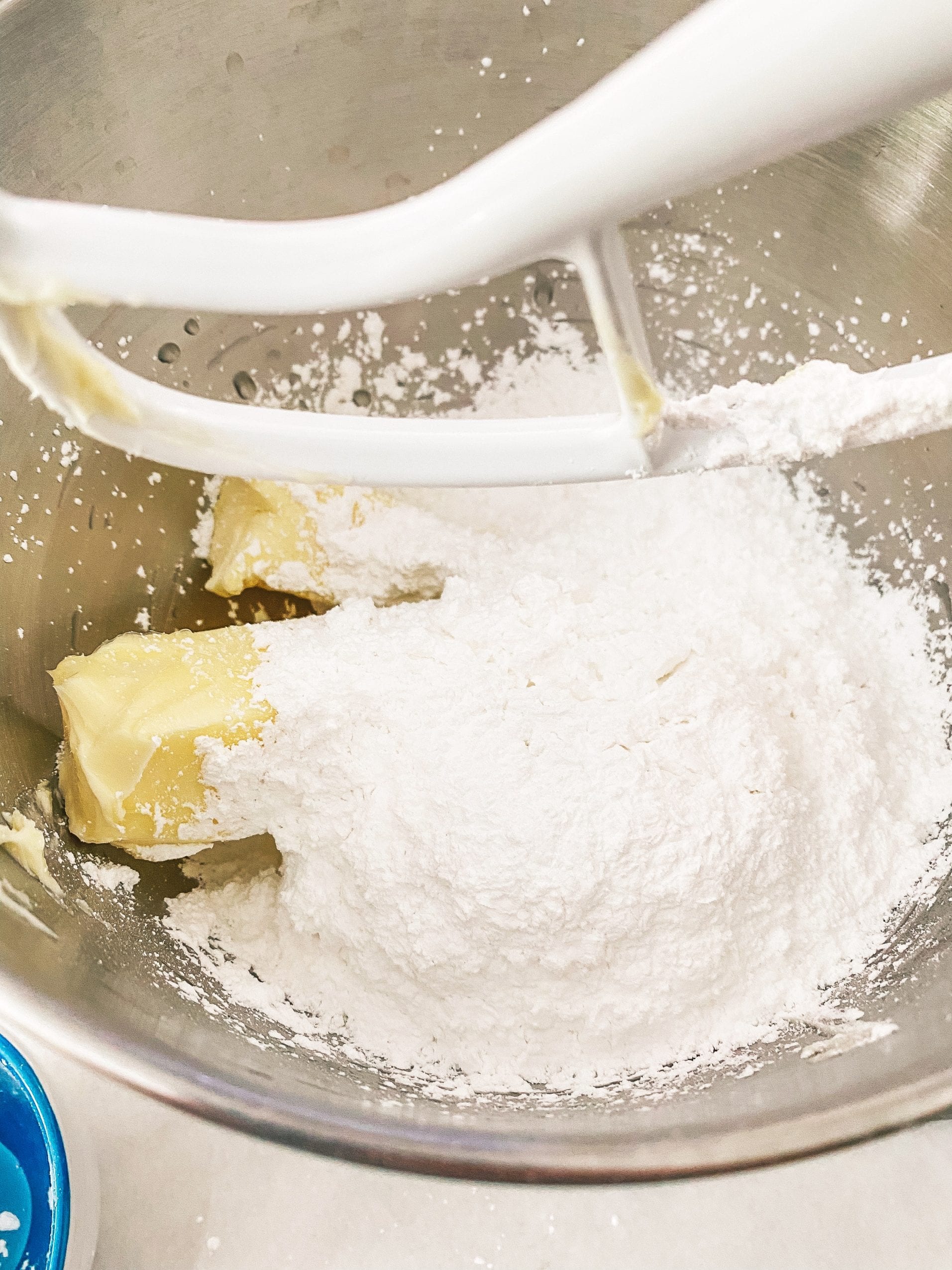 Adding butter and powdered sugar for buttercream
