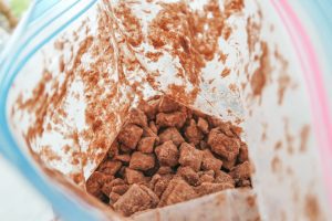 adding the cereal mix to the bag of red velvet cake mix