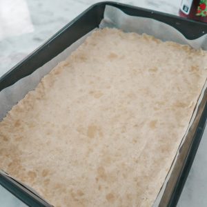 pressing the dough to create bottom layer