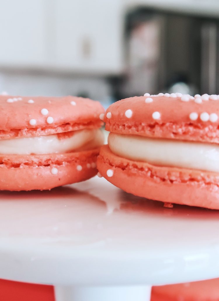 pink macarons with a cream cheese buttercream filling on a dish