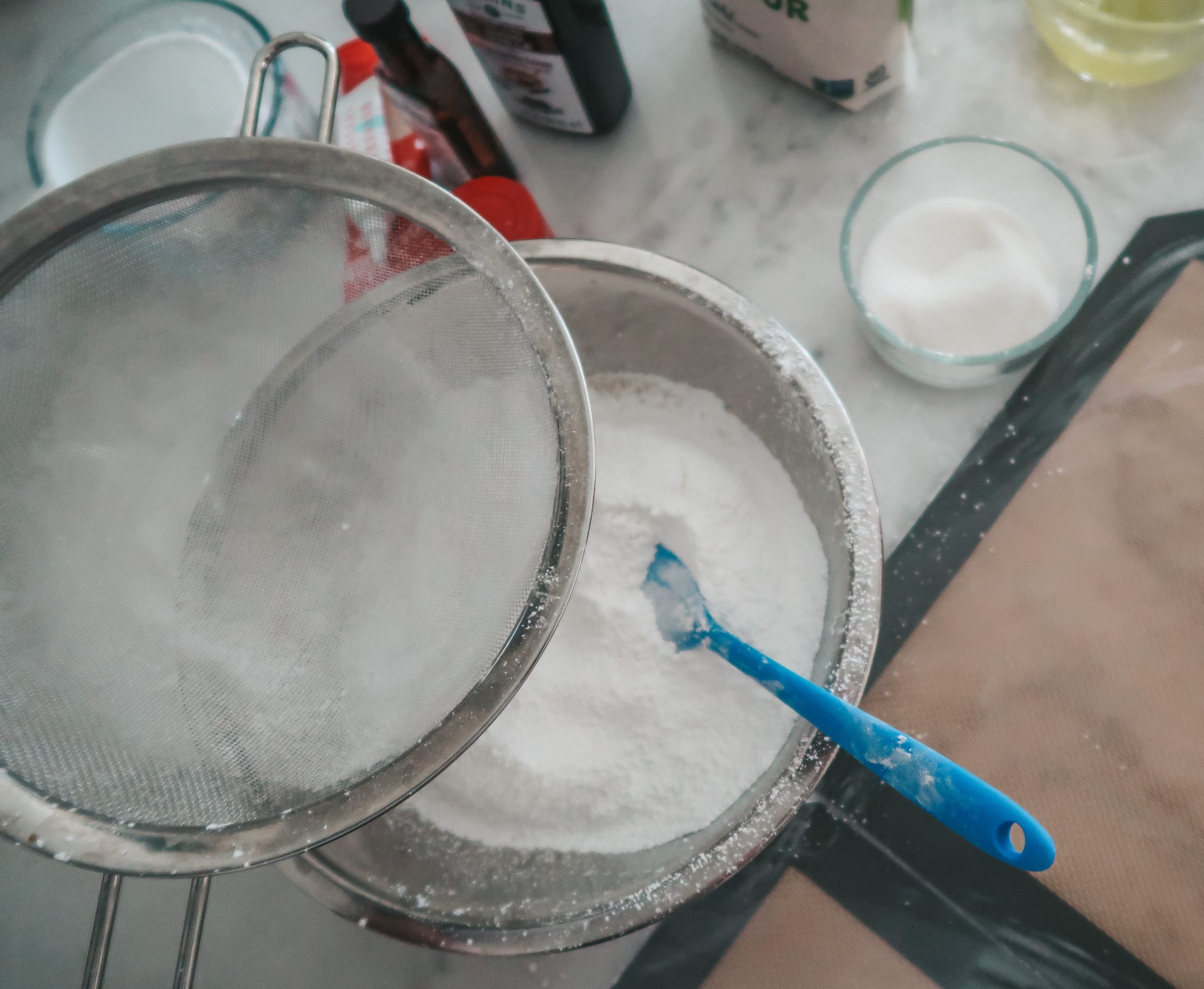 sifting the powdered sugar and almond flour