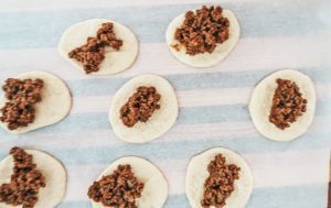 adding taco meat