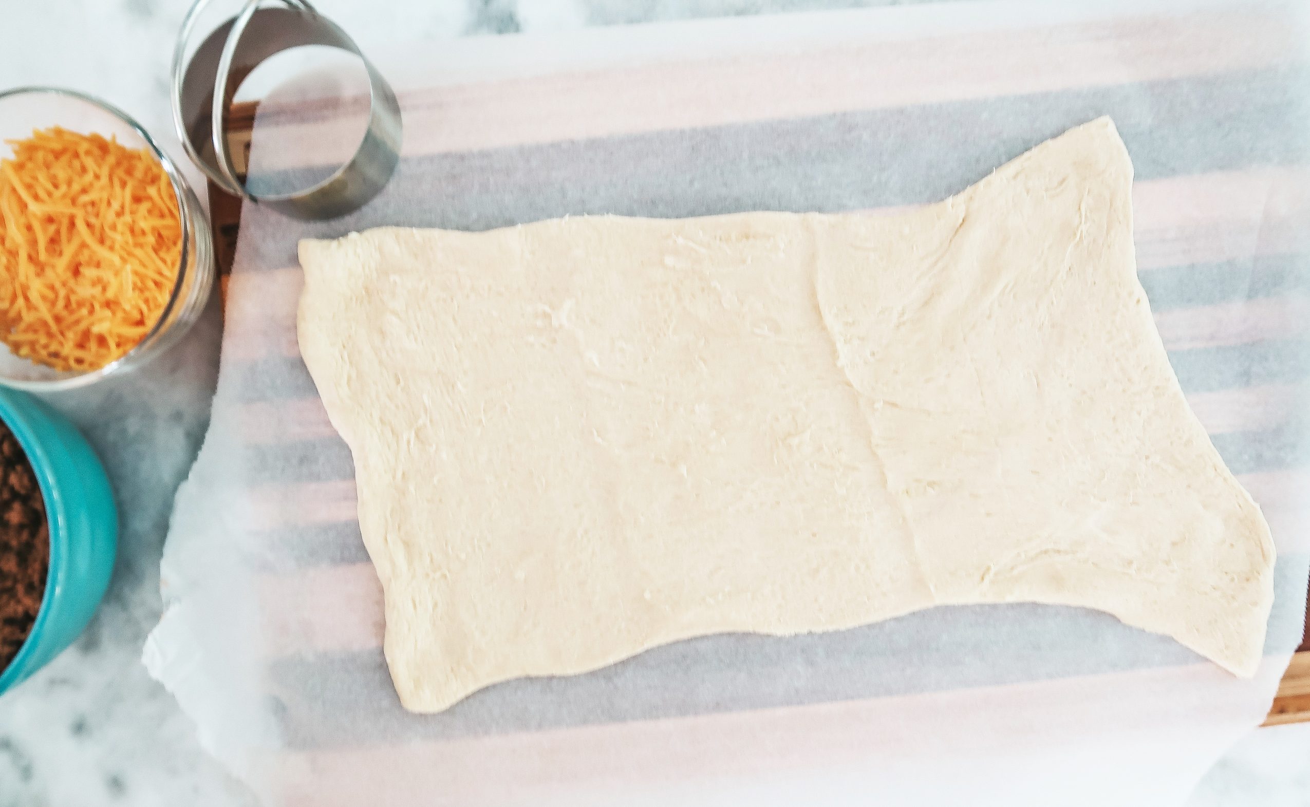 rolling out the crescent roll dough sheet