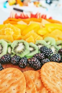 preparing the rainbow fruit charcuterie board