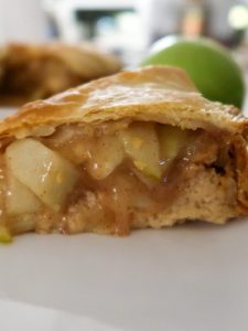 slice of the delicious and easy stuffed apple pie cheesecake