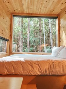 getaway cabin large window over bed