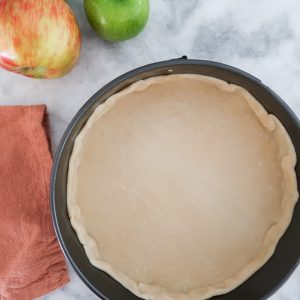 pressing pie crust into a spring form pan