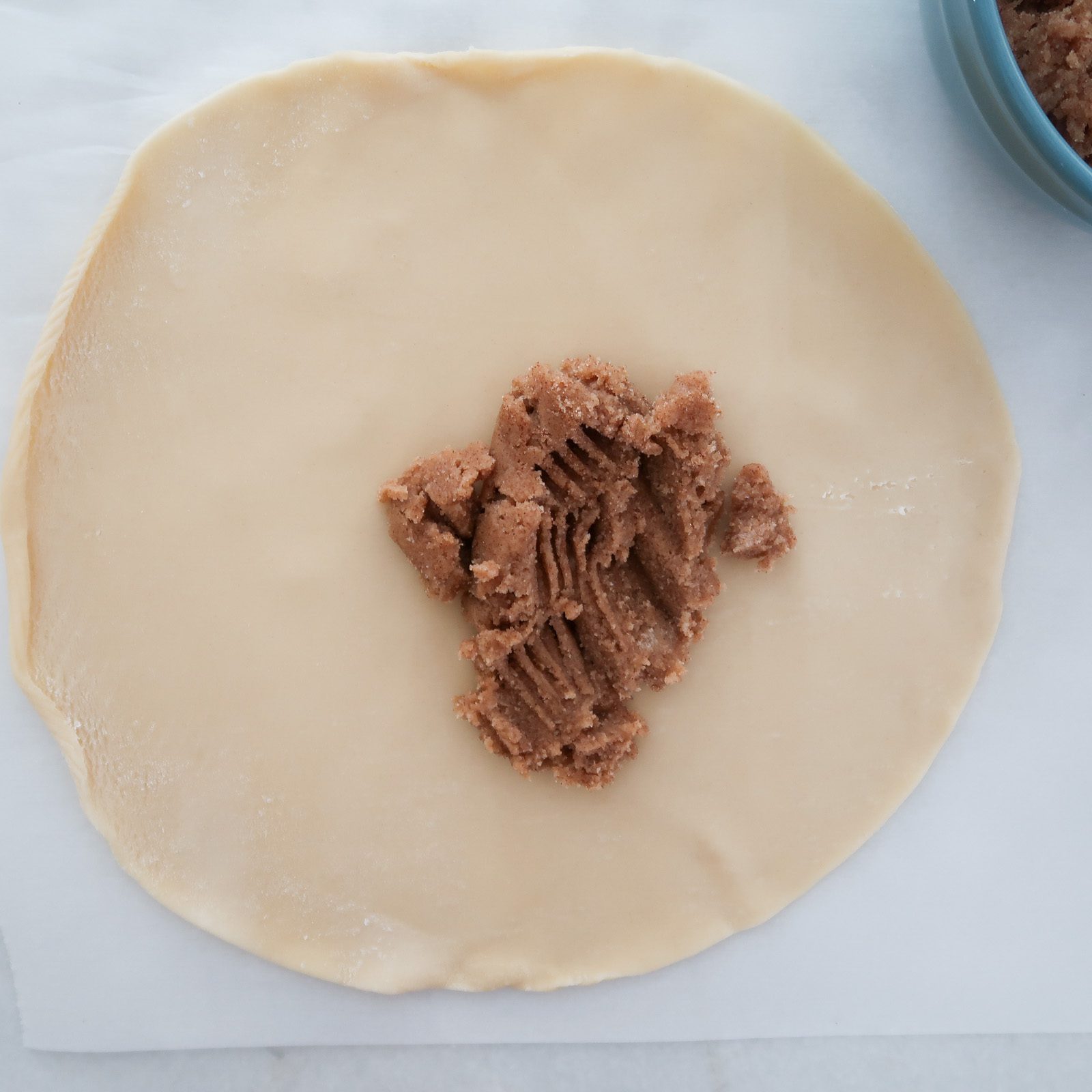 adding cinnamon and sugar butter to pie dough crust