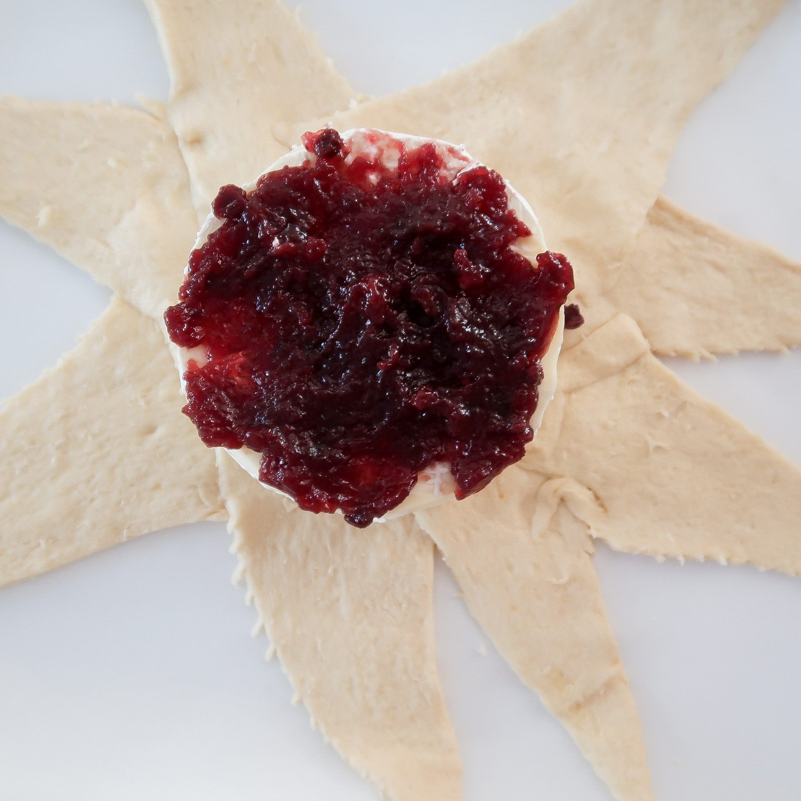 adding the raspberry preserves on top of the brie