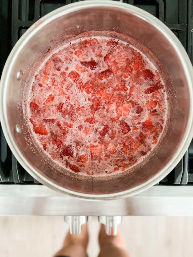 boiling the smashed strawberries and sugar