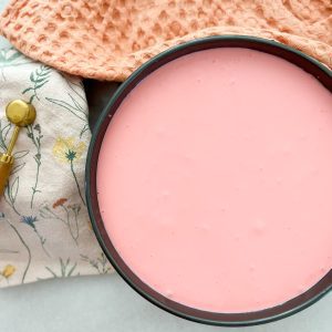 pouring cheesecake batter into the the springform pan