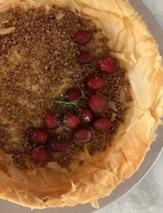 closeup photo of the candied cranberries on the simple baklava cheesecake